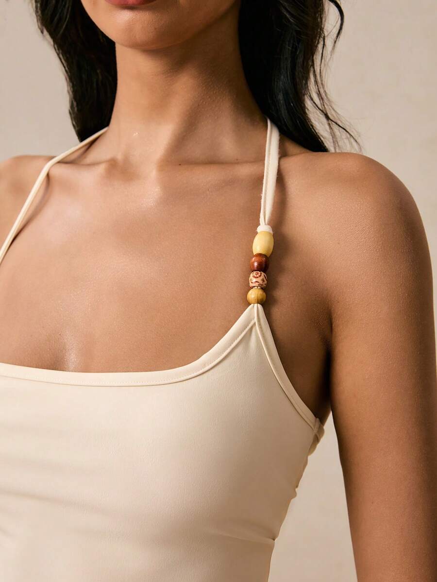 Women's solid color beaded backless crop top, fashionable and slim, suitable for vacations, beach vacations, summer outings and other occasions, bohemian style, European summer style Women's solid color beaded backless crop top, fashionable and slim, suitable for vacations, beach vacations, summer outings and other occasions, bohemian style, European summer style